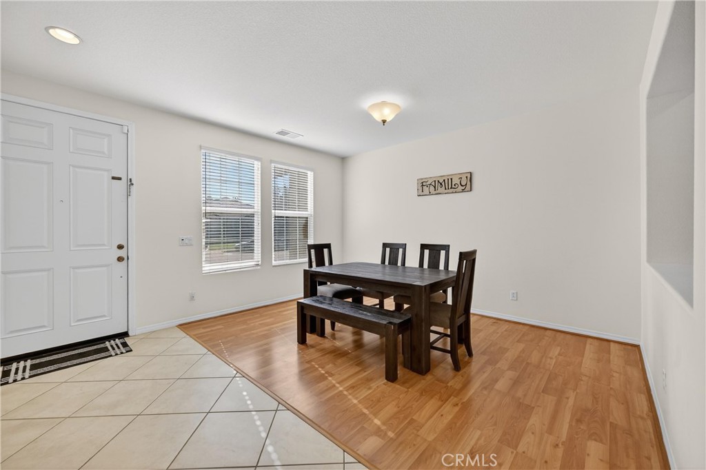 34581 Spindle Tree Street Winchester, CA 92596 - Photo 8 of 50 a dining room with a wooden table and chairs