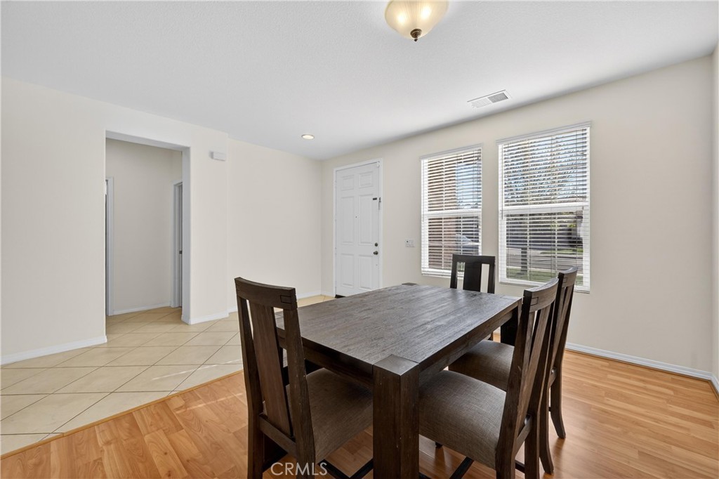 34581 Spindle Tree Street Winchester, CA 92596 - Photo 9 of 50 a view of a dining room with furniture window and wooden floor