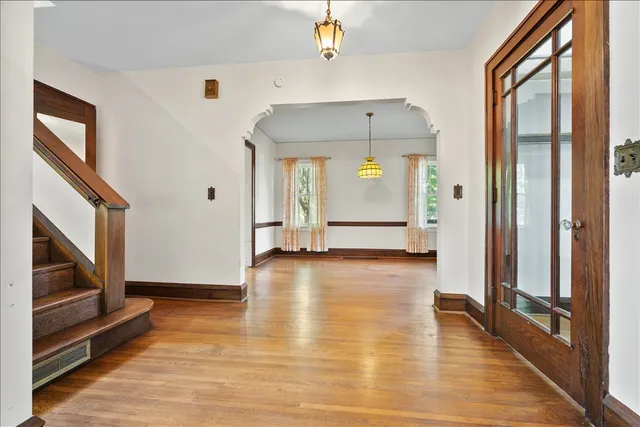 a view of a hallway view with wooden floor and staircase
