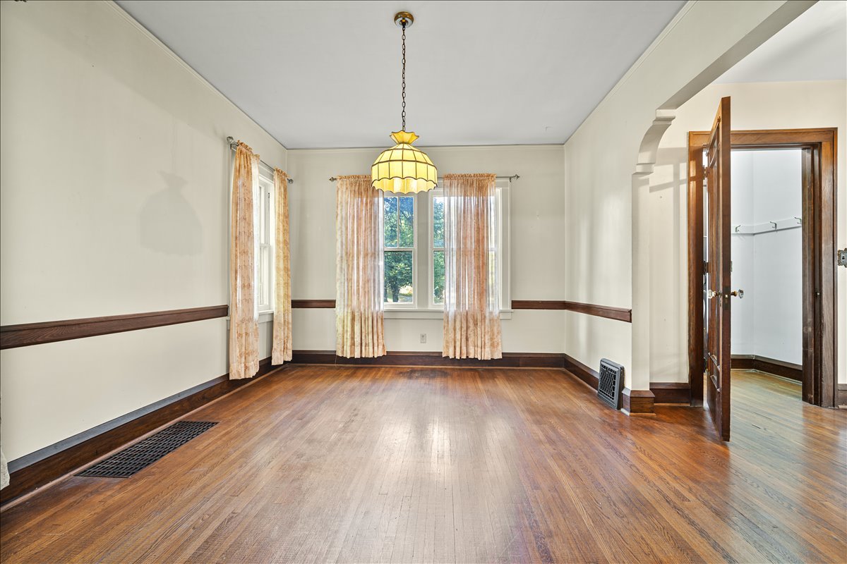 713 Normal Avenue Normal, IL 61761 - Photo 16 of 43 a view of an empty room with wooden floor and a window