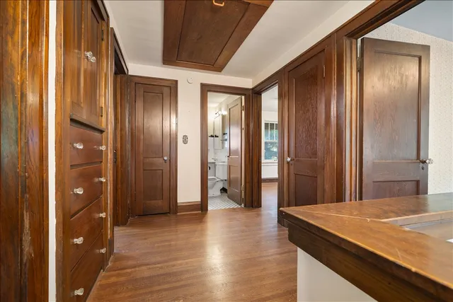a view of a hallway with wooden floor