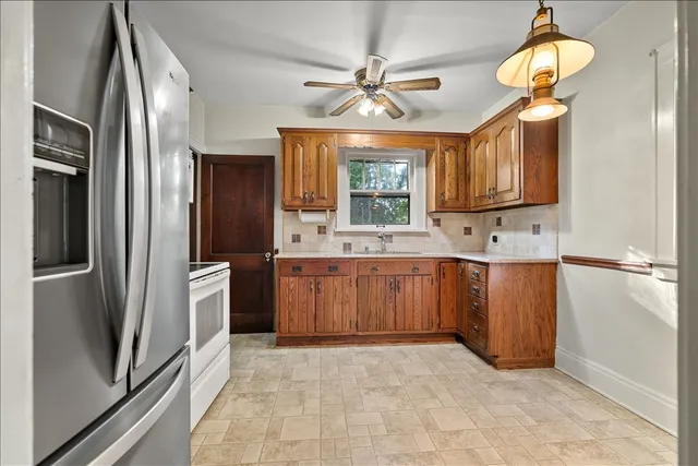 a kitchen with stainless steel appliances a refrigerator sink and cabinets