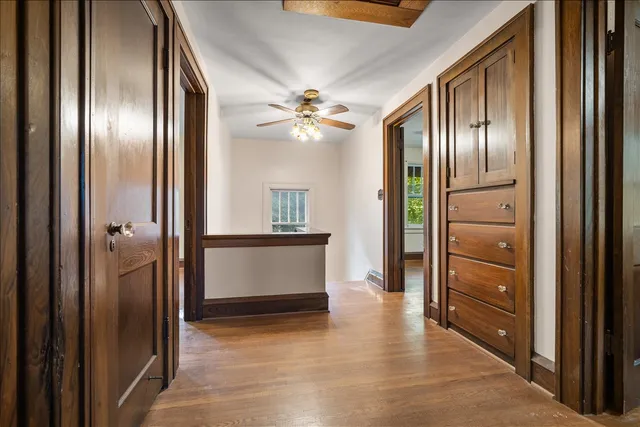 a view of a hallway with wooden floor