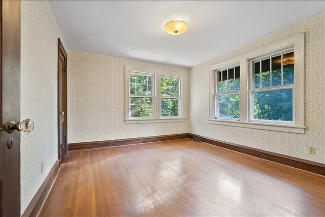 wooden floor in an empty room with a window