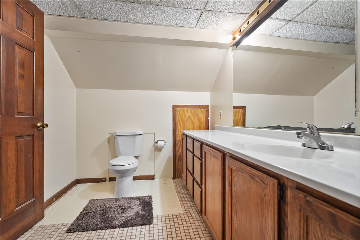 713 Normal Avenue Normal, IL 61761 - Photo 31 of 43 a bathroom with a sink a toilet and a mirror