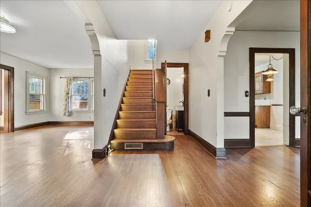 a view of a room with wooden floor and stairs