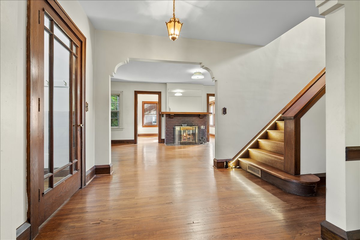 713 Normal Avenue Normal, IL 61761 - Photo 9 of 43 a view of a hallway with wooden floor and staircase