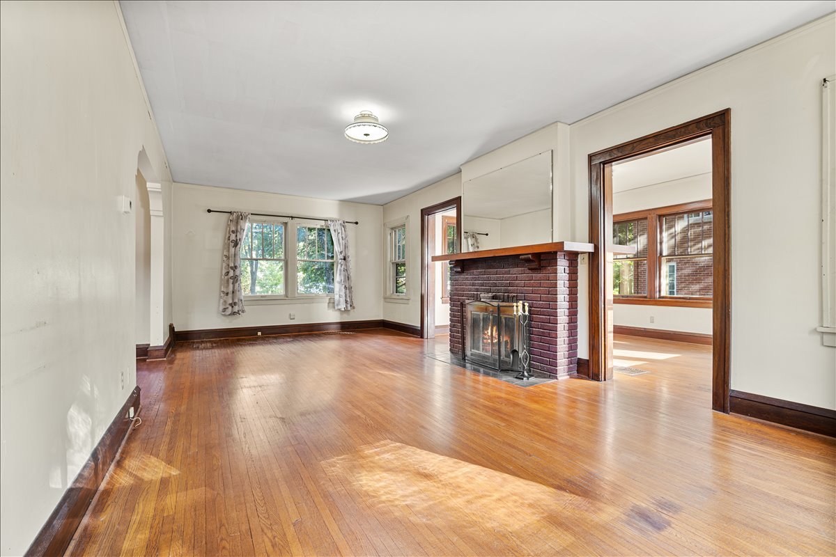 713 Normal Avenue Normal, IL 61761 - Photo 10 of 43 a view of a livingroom with wooden floor and a fireplace