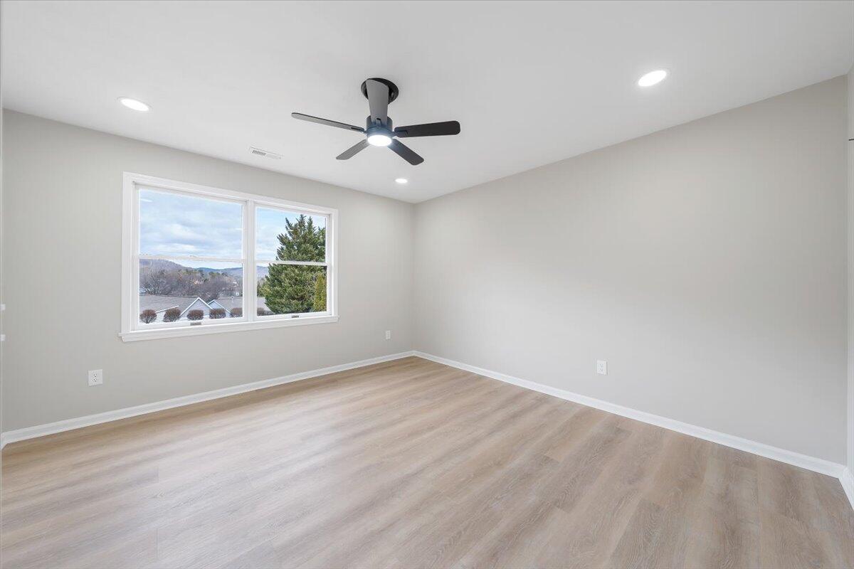 7951 Barrens Road Roanoke, VA 24019 - Photo 44 of 105 an empty room with wooden floor fan and windows