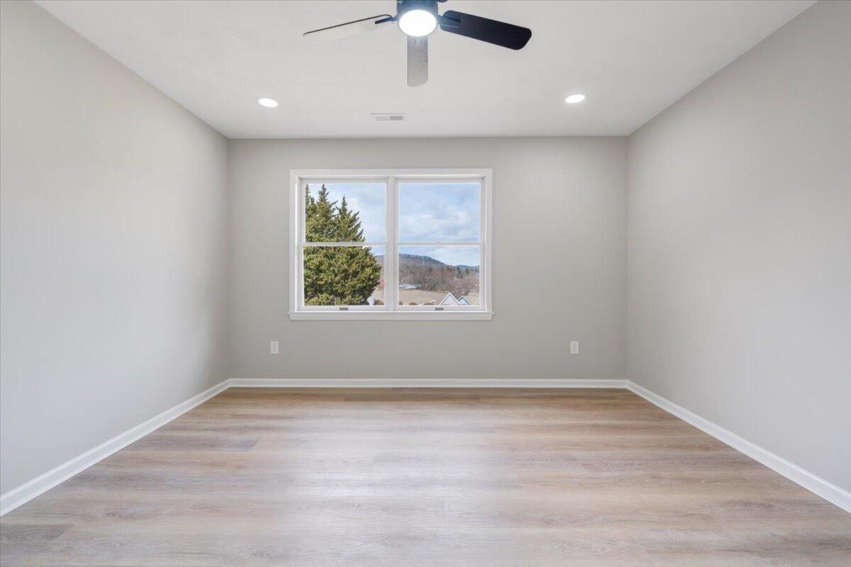 7951 Barrens Road Roanoke, VA 24019 - Photo 45 of 105 an empty room with a window and a ceiling fan