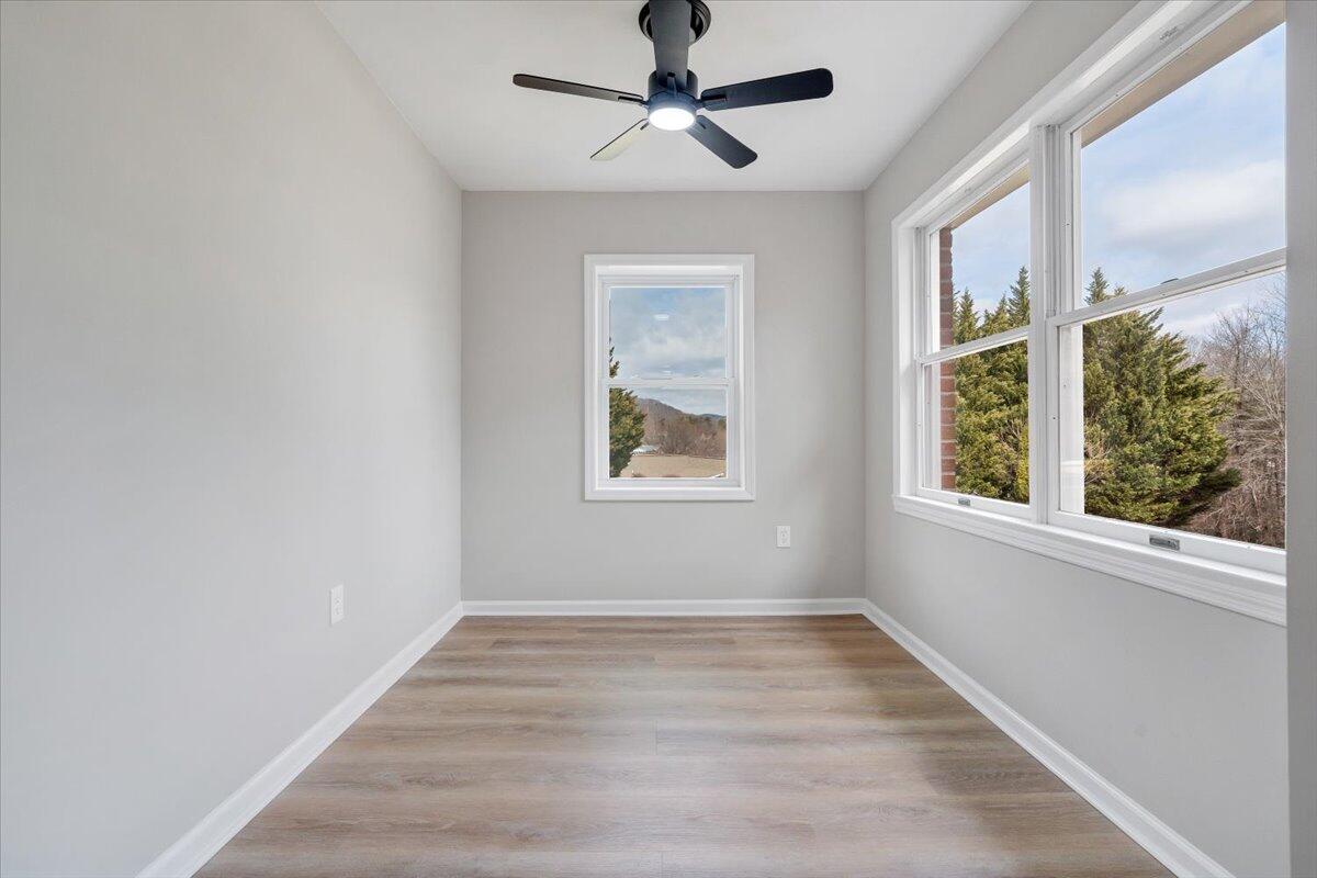 7951 Barrens Road Roanoke, VA 24019 - Photo 49 of 105 a view of an empty room with a window and wooden floor
