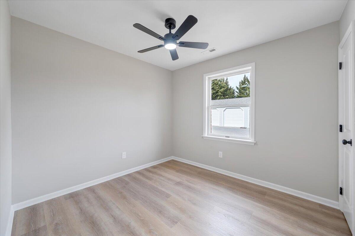 7951 Barrens Road Roanoke, VA 24019 - Photo 57 of 105 an empty room with ceiling fan and windows