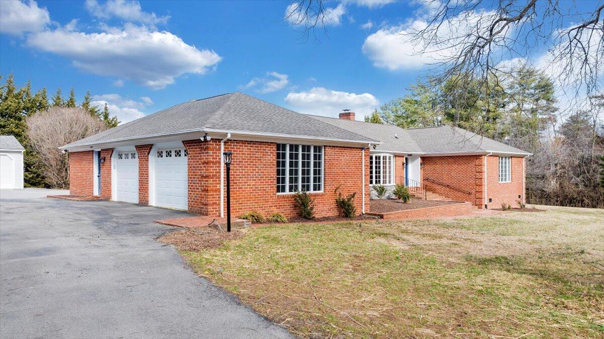 7951 Barrens Road Roanoke, VA 24019 - Photo 94 of 105 a front view of a house with a yard and garage