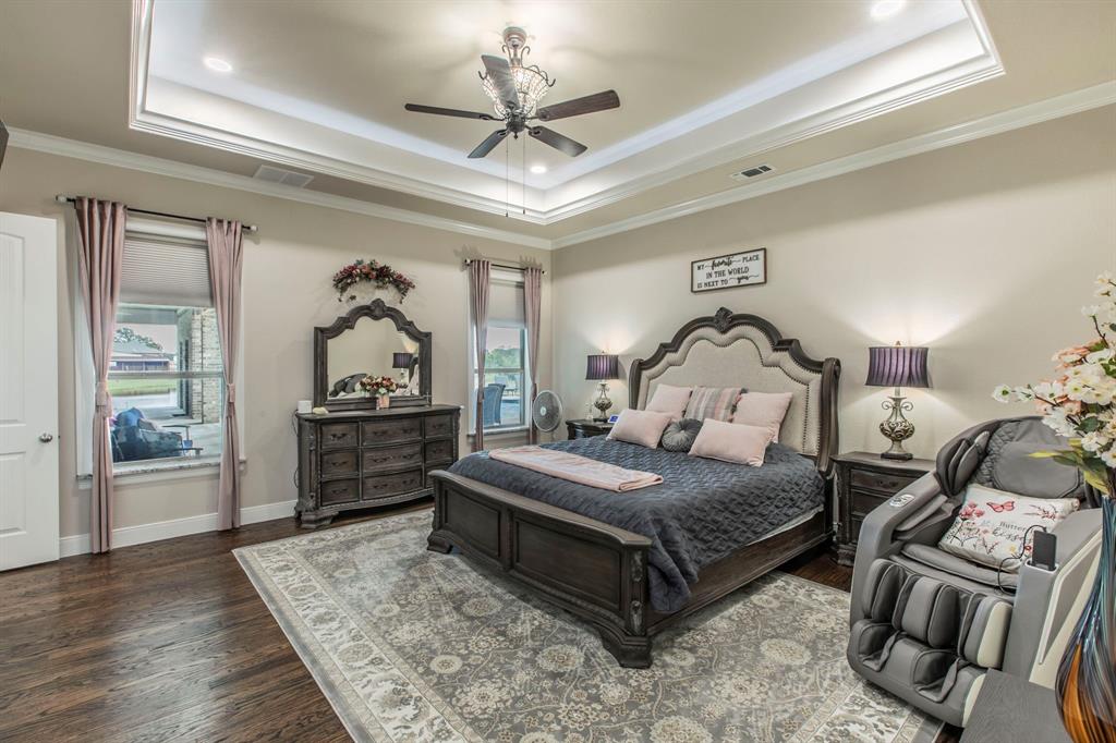 790 Bones Chapel Road Whitesboro, TX 76273 - Photo 14 of 36 a bedroom with a bed and wooden floor