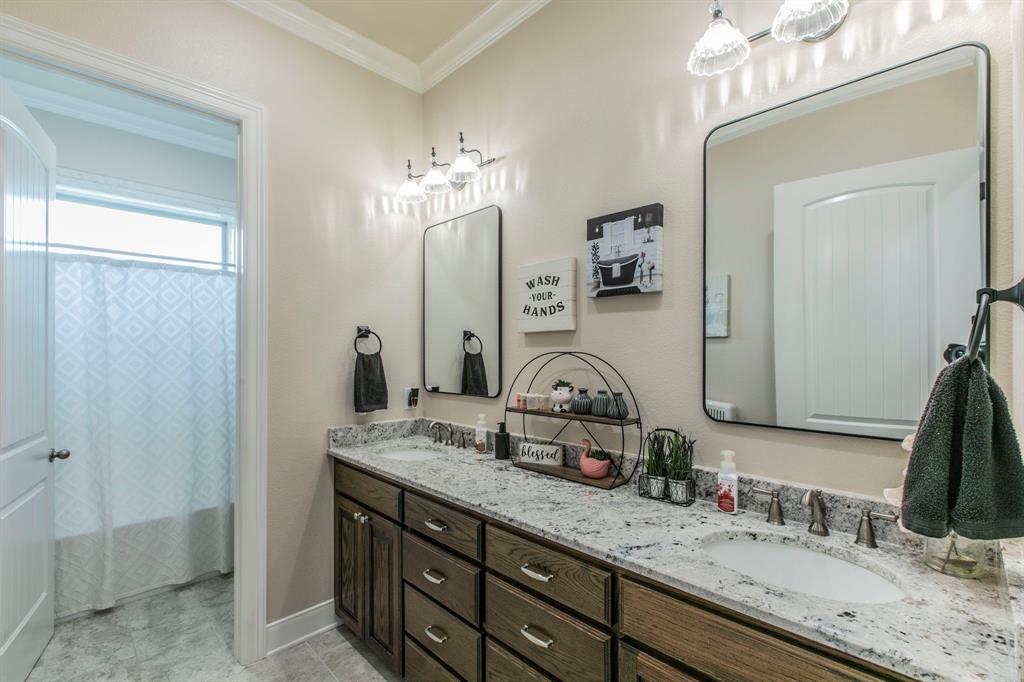 790 Bones Chapel Road Whitesboro, TX 76273 - Photo 20 of 36 a bathroom with double vanity sinks a vanity a lamp and a mirror