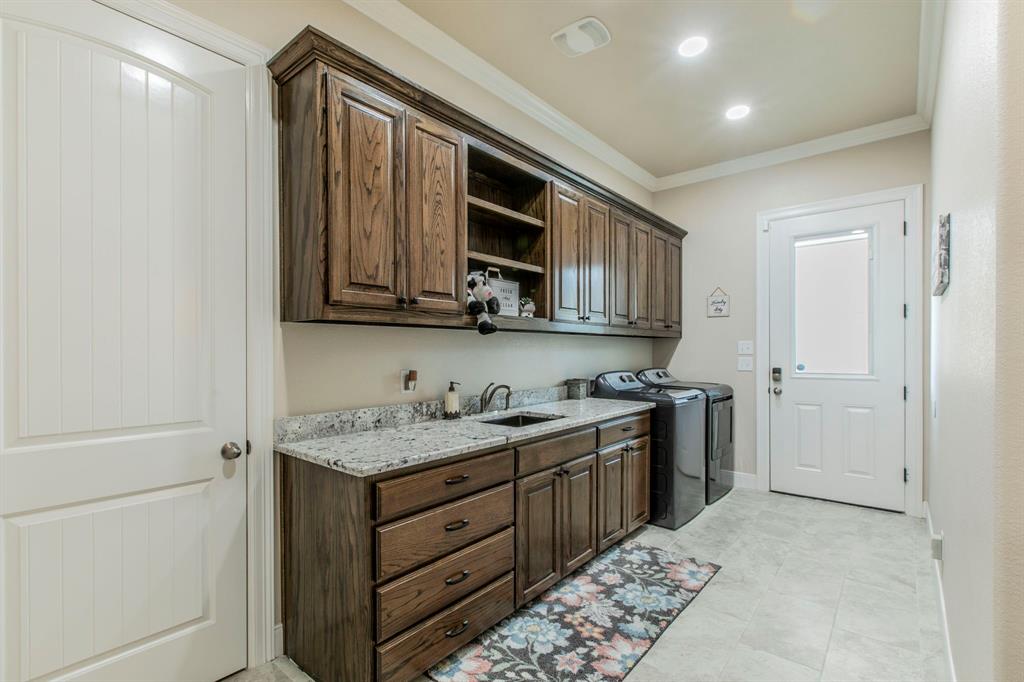 790 Bones Chapel Road Whitesboro, TX 76273 - Photo 21 of 36 a kitchen with a sink stove and cabinets