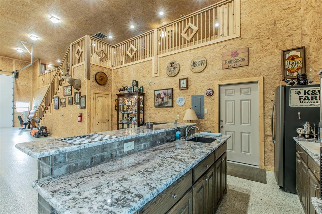 790 Bones Chapel Road Whitesboro, TX 76273 - Photo 28 of 36 a bathroom with a granite countertop sink and a mirror