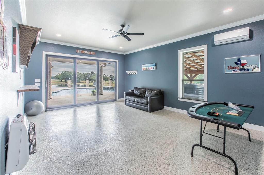790 Bones Chapel Road Whitesboro, TX 76273 - Photo 29 of 36 a living room with furniture and a floor to ceiling window