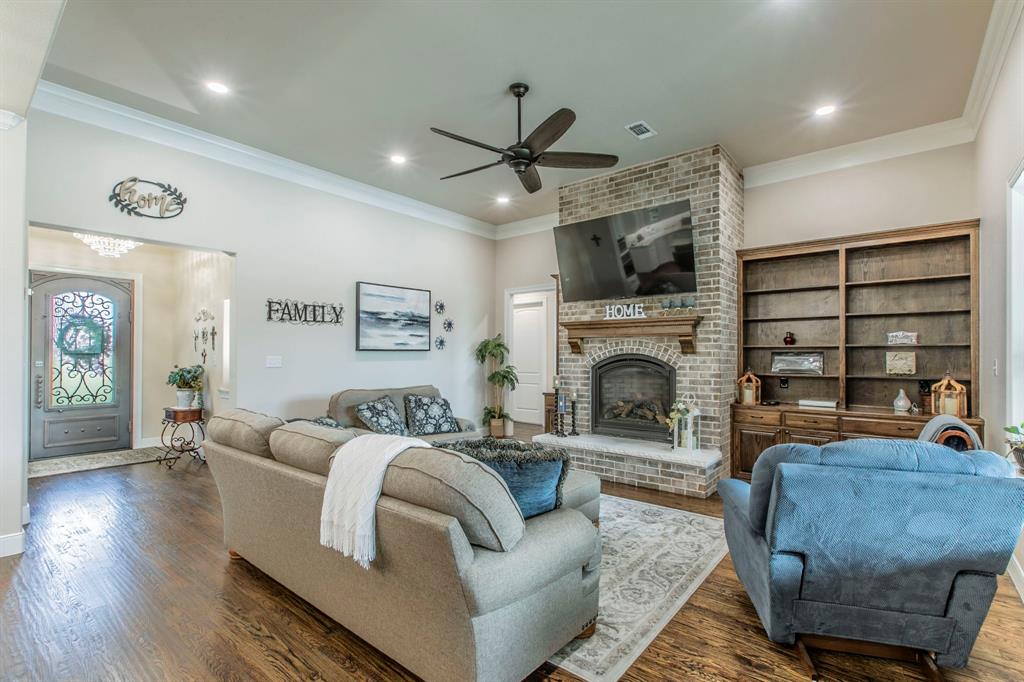 790 Bones Chapel Road Whitesboro, TX 76273 - Photo 4 of 36 a living room with furniture a flat screen tv and a fireplace