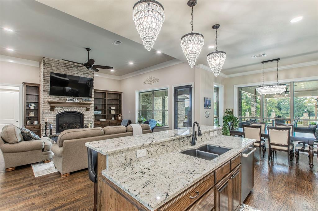 790 Bones Chapel Road Whitesboro, TX 76273 - Photo 7 of 36 a view of a livingroom with furniture window wooden floor and a chandelier