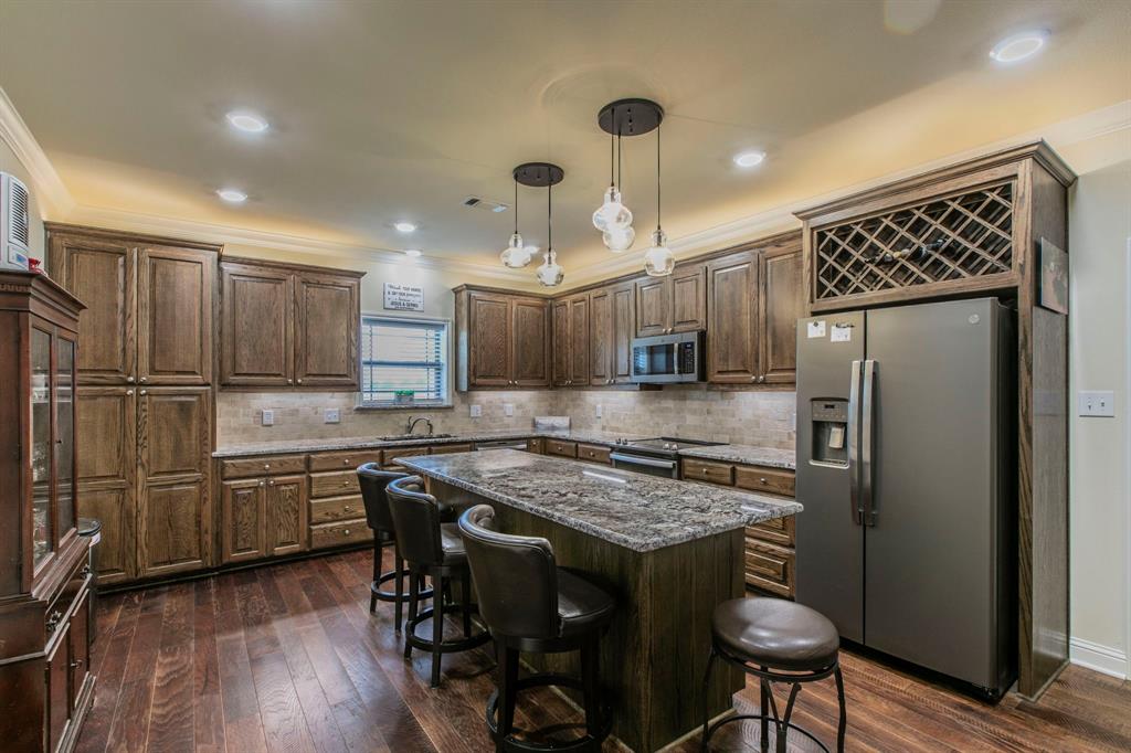 790 Bones Chapel Road Whitesboro, TX 76273 - Photo 10 of 36 a kitchen with stainless steel appliances granite countertop a refrigerator and a stove top oven