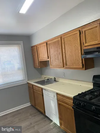 a kitchen with a sink and a stove