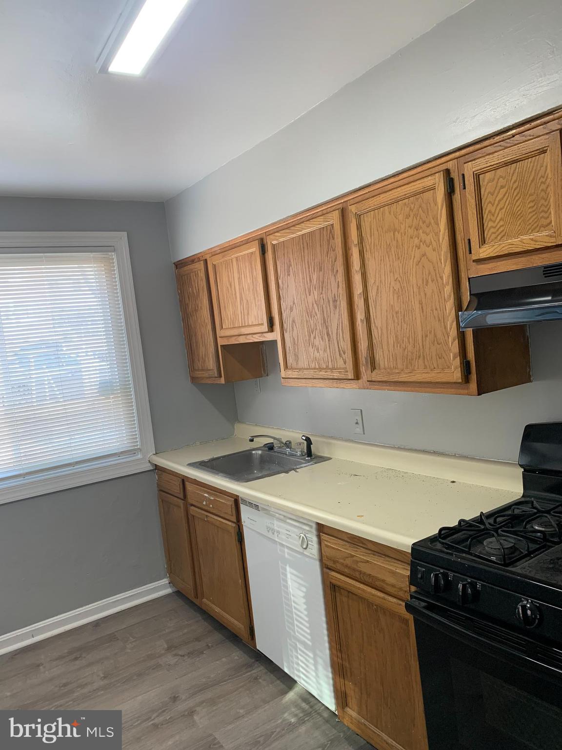 5404 67th Avenue Riverdale, MD 20737 - Photo 11 of 11 a kitchen with a sink and a stove