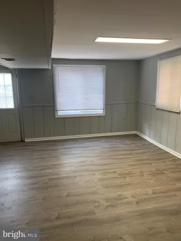a view of a room with wooden floor and window