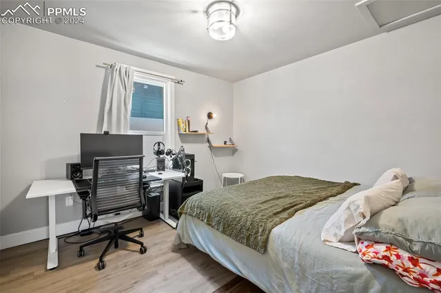 a bedroom with a bed and a desk