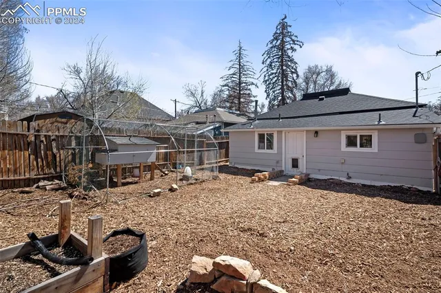 a backyard of a house with barbeque oven and outdoor seating