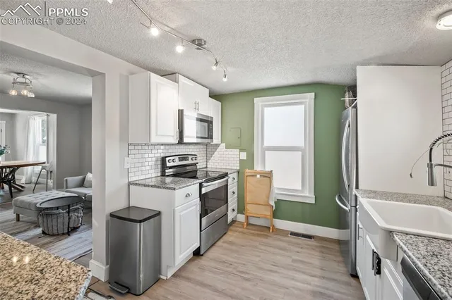 a kitchen with a sink stove and refrigerator