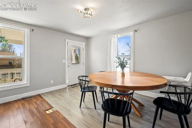 a view of a dining room with furniture window and wooden floor