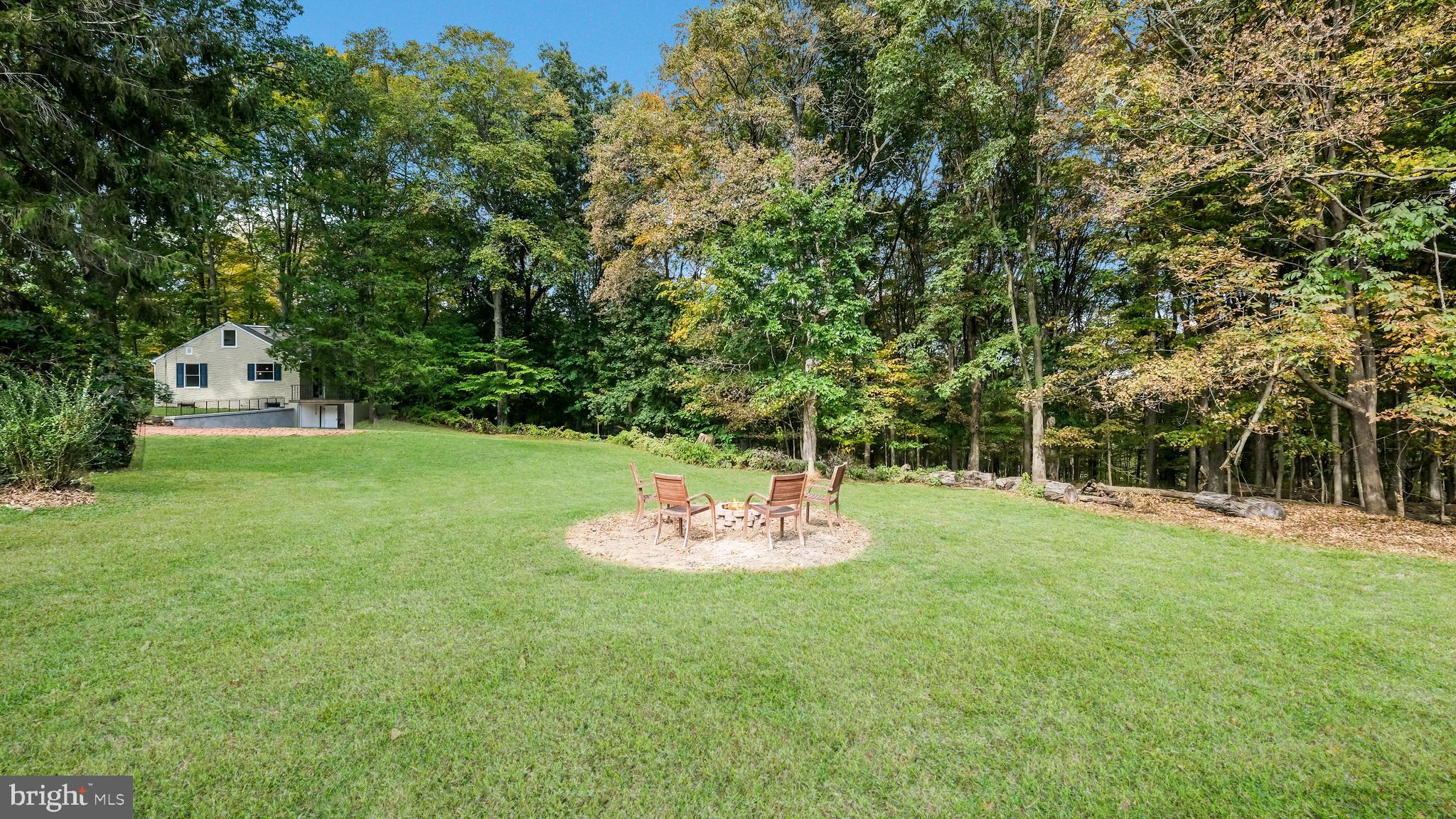 2443 Sugar Bottom Road Furlong, PA 18925 - Photo 34 of 39 a backyard of a house with table and chairs