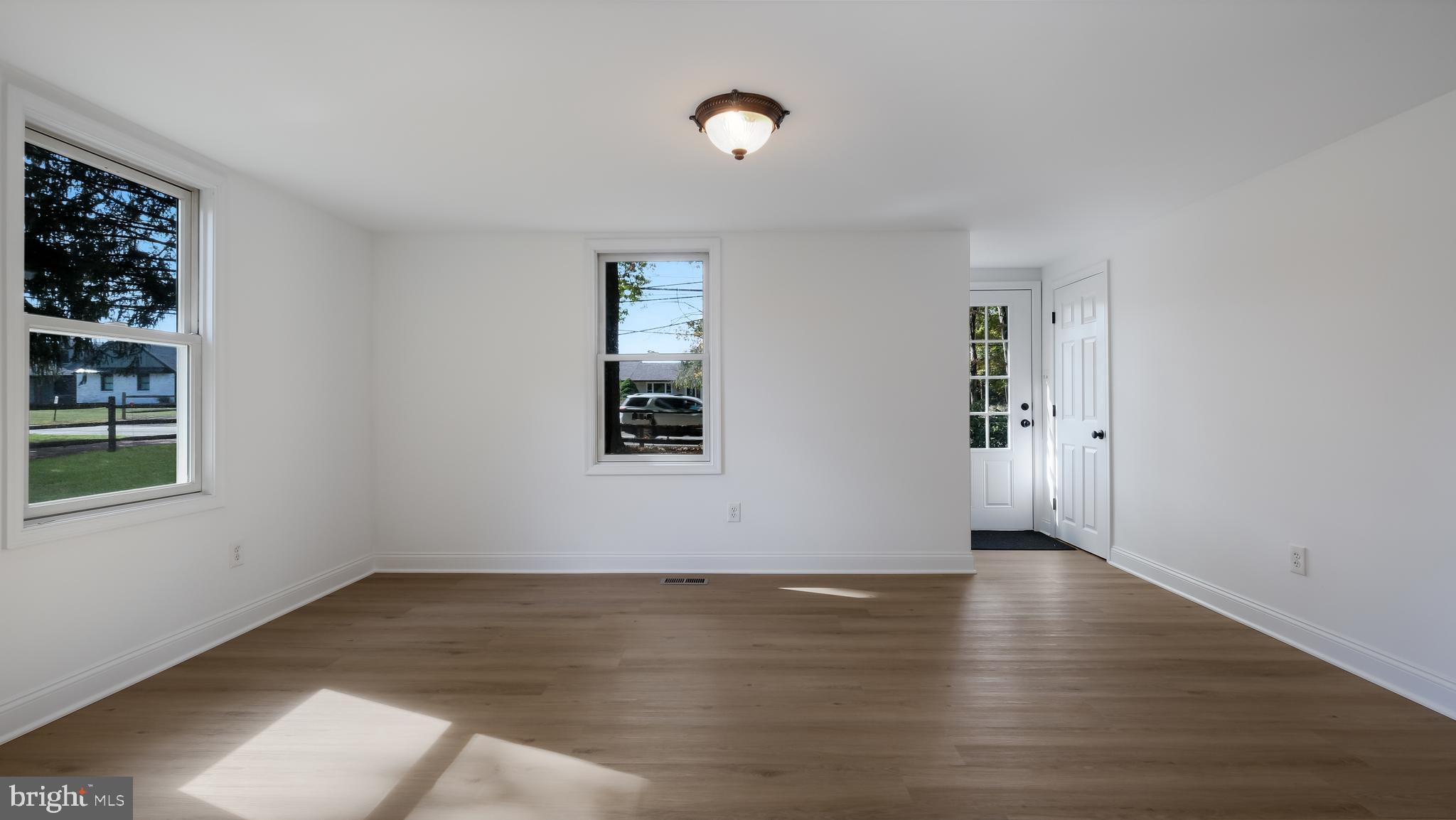 2443 Sugar Bottom Road Furlong, PA 18925 - Photo 6 of 39 a view of an empty room with wooden floor and a window