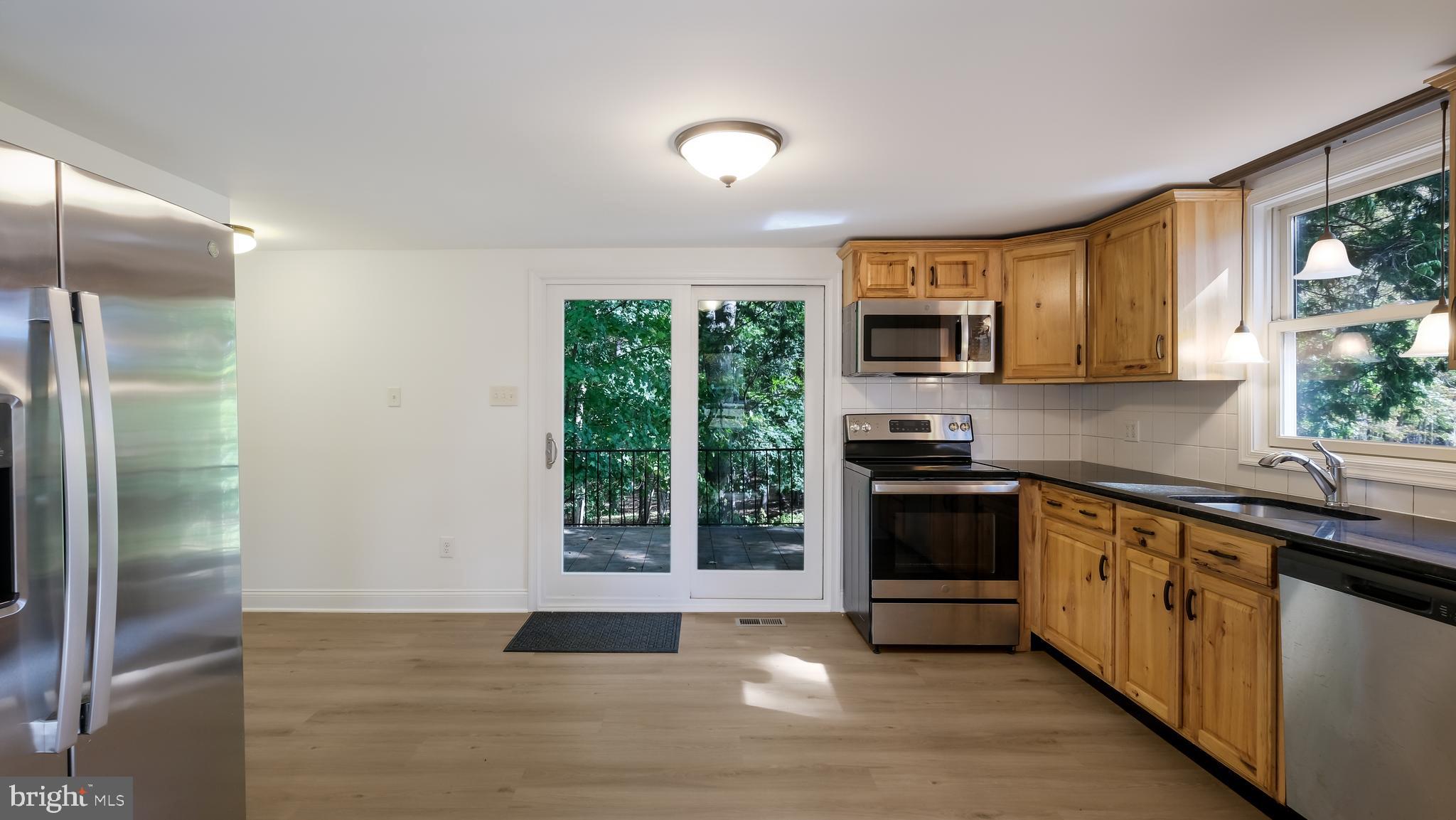 2443 Sugar Bottom Road Furlong, PA 18925 - Photo 8 of 39 a kitchen with stainless steel appliances granite countertop a stove a sink and a refrigerator