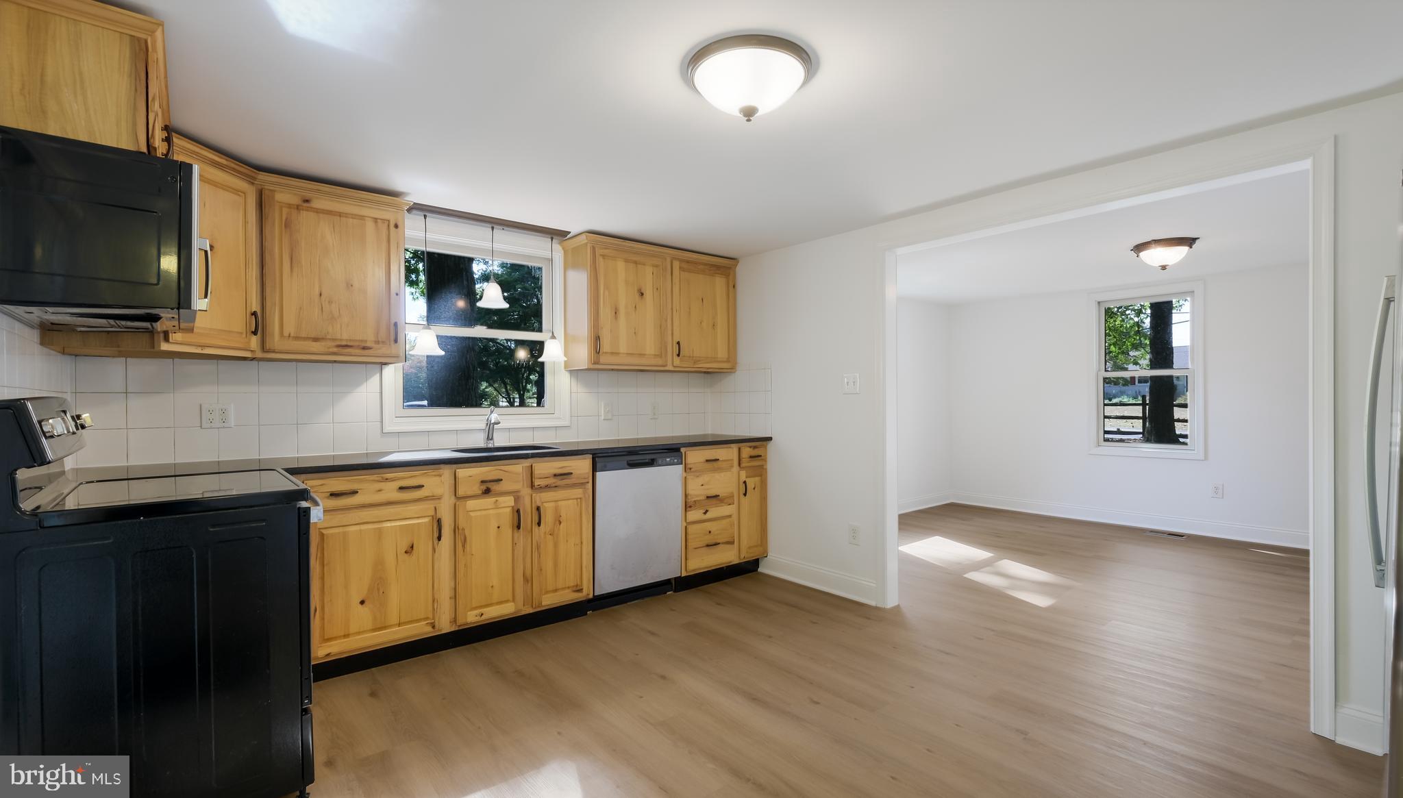 2443 Sugar Bottom Road Furlong, PA 18925 - Photo 10 of 39 a kitchen with stainless steel appliances granite countertop a stove a sink and a microwave