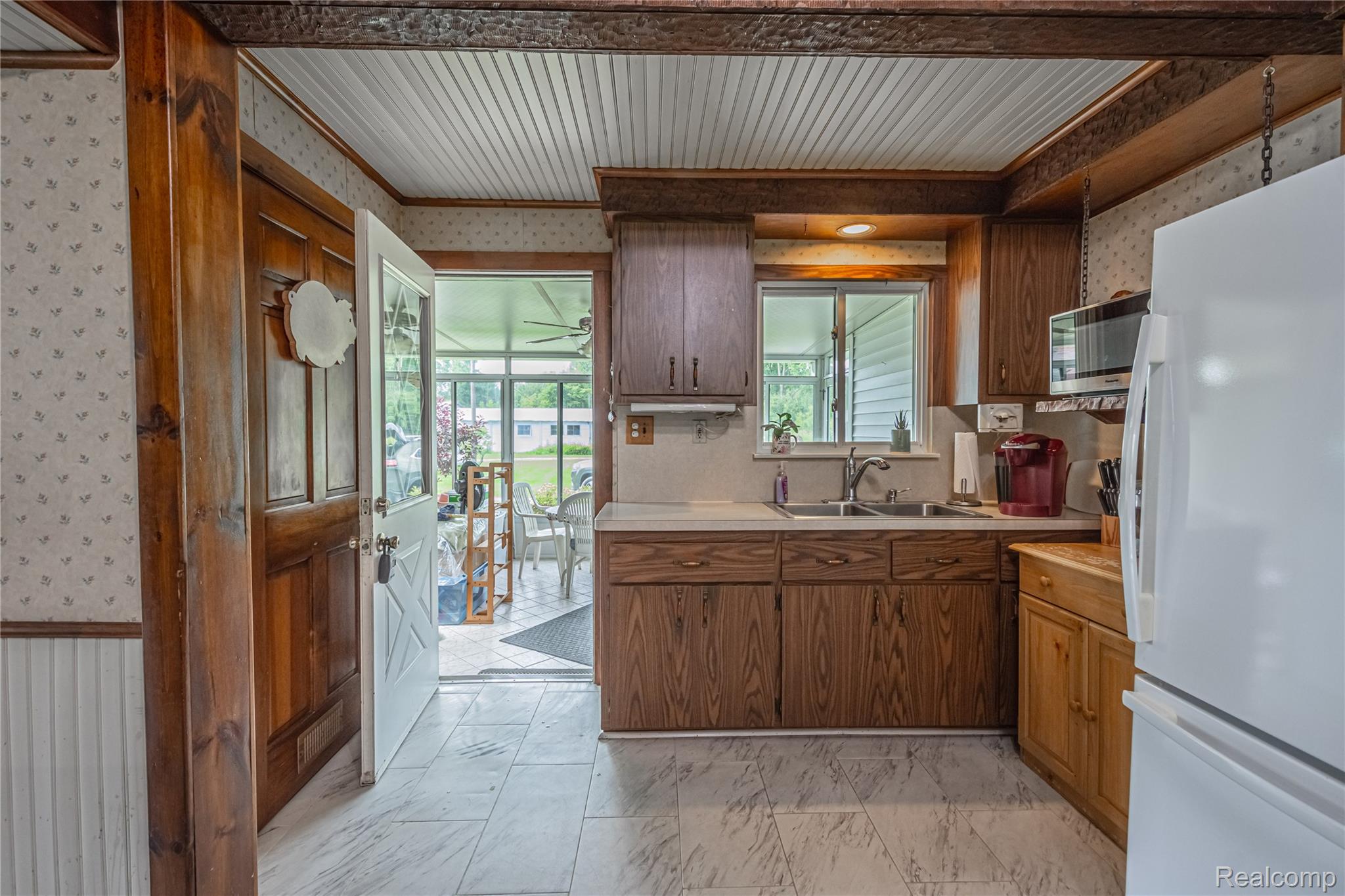 8384 Imlay City Road Avoca, MI 48006 - Photo 26 of 39 Kitchen featuring wood cabinetry, laminate countertops, and a stainless steel sink