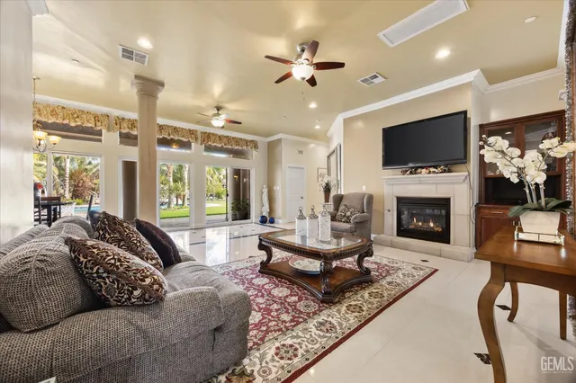 a living room with furniture a flat screen tv and a fireplace