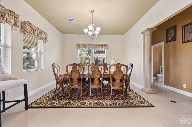 a view of a dining room with furniture and chandelier