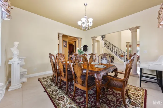 a view of a dining room with furniture and a chandelier