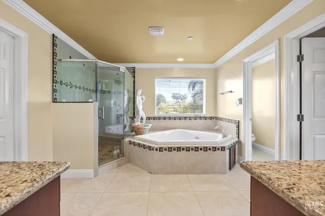 a spacious bathroom with a granite countertop sink and a mirror