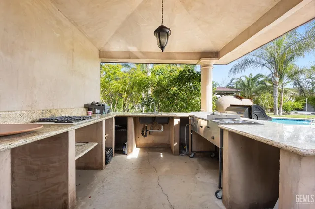a kitchen with a sink stove and cabinets