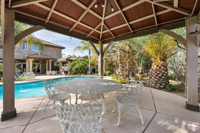 a view of a porch with furniture and a yard