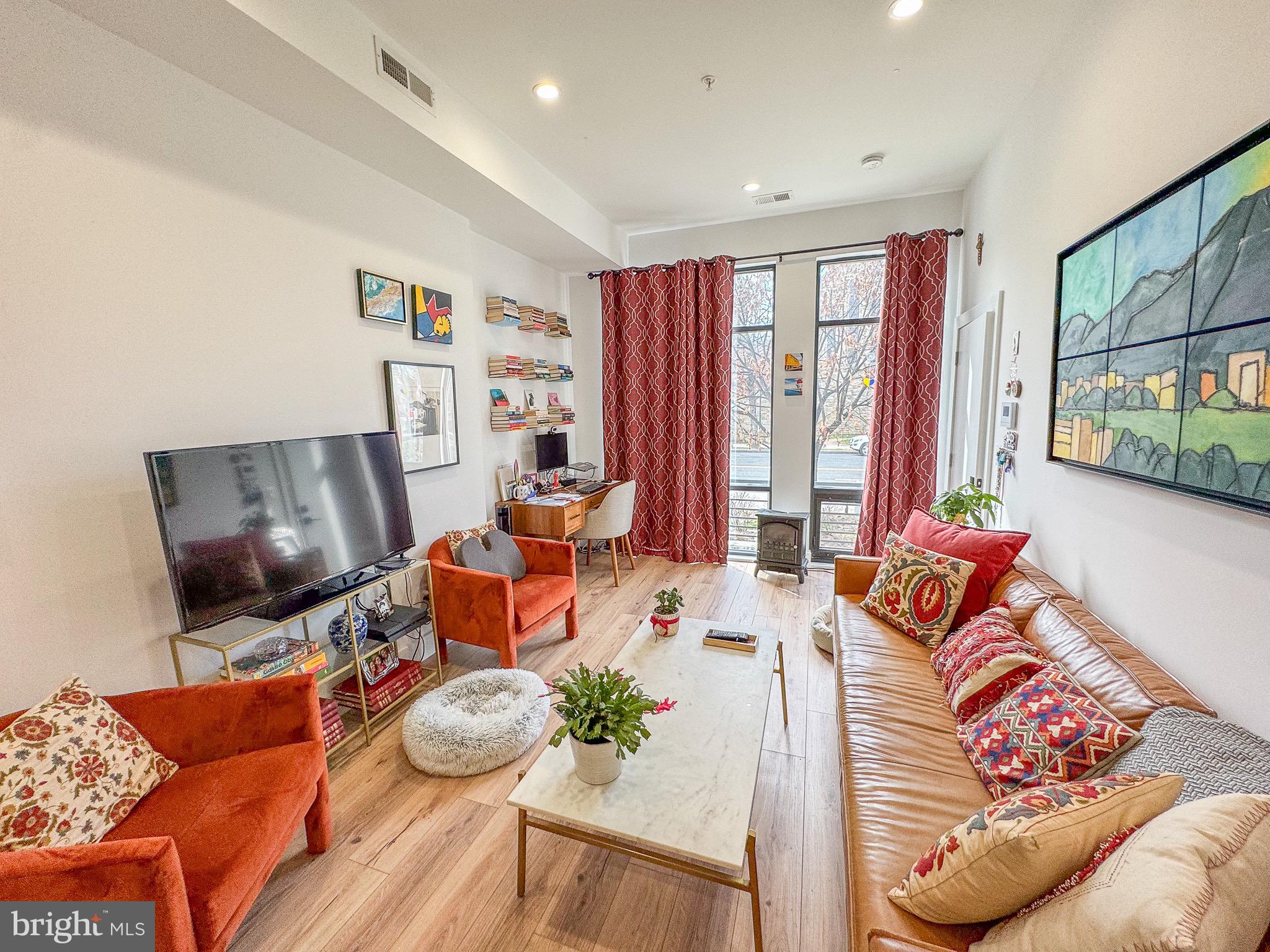 5309 Connecticut Avenue Northwest, Unit 1 Washington, DC 20015 - Photo 5 of 16 a living room with furniture and a flat screen tv