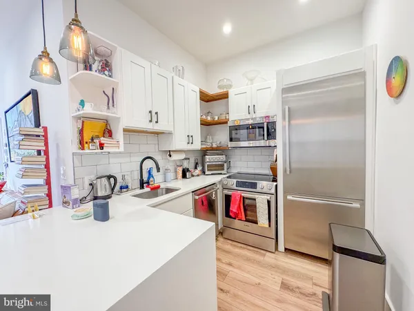 a kitchen with a refrigerator and a sink