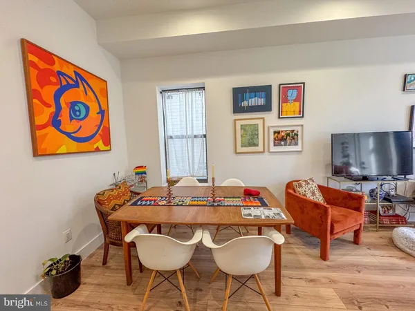 a dining room with furniture and wooden floor
