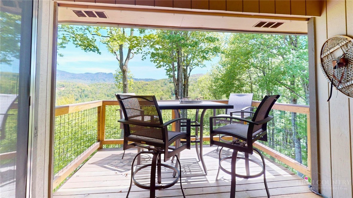 250 Ridgeview Road, Unit 43 Sugar Mountain, NC 28604 - Photo 3 of 21 a view of a porch with furniture and wooden floor