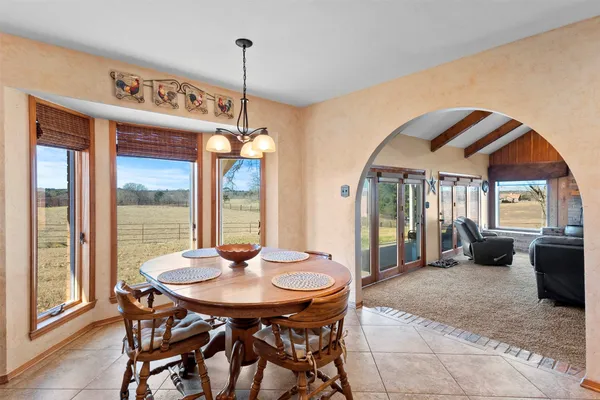 a dinning table and chairs in a room