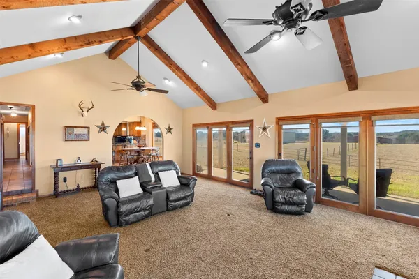 a living room with furniture and a floor to ceiling window