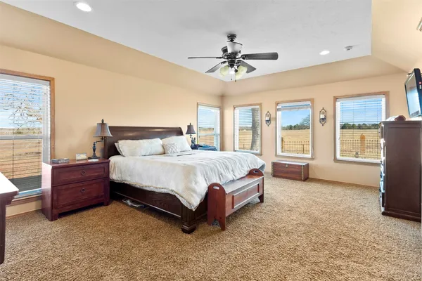 a spacious bedroom with a bed and window